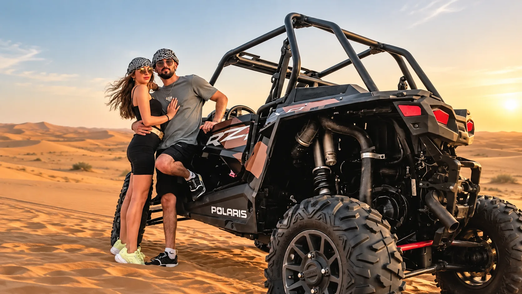 Couple beside an off-road buggy on the dunes